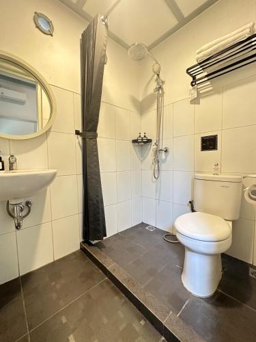 a bathroom with a toilet and a sink at CERIA HOTEL at Alun Alun Yogyakarta in Yogyakarta