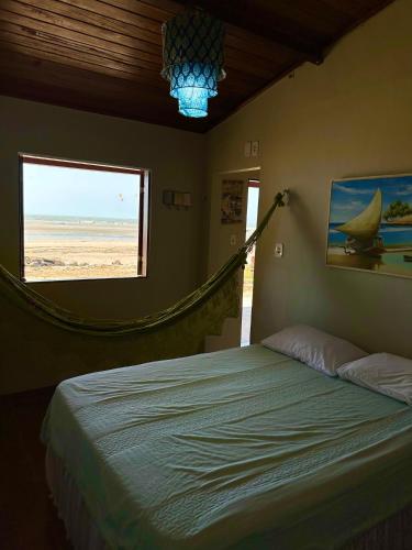 a bedroom with a bed with a view of the beach at Casa do Pescador - Praia do Maceió - Camocim - CE in Camocim