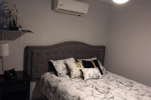 a bedroom with a bed with pillows on it at Praderas in Los Mochis