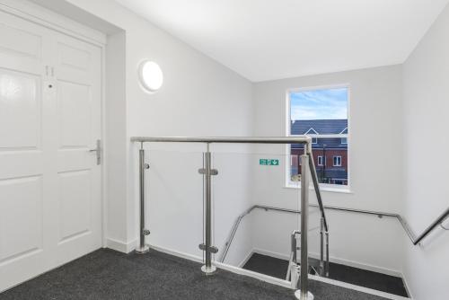 an empty room with a treadmill and a window at Beaver Stays- Coventry Serviced Apartment in Coventry