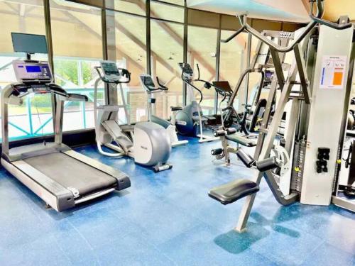 a gym with several treadmills and cardio machines at Country Retreat Horseshoe Valley in Shanty Bay