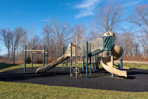 a playground with a slide in a park at Country Retreat Horseshoe Valley in Shanty Bay