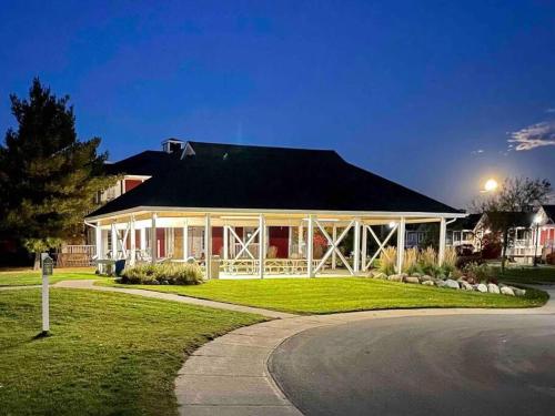 a large white house with a black roof at Country Retreat Horseshoe Valley in Shanty Bay