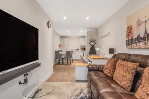 a living room with a couch and a tv at Beaver Stays- Coventry Serviced Apartment in Coventry
