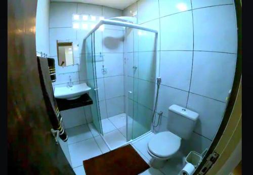 a bathroom with a shower and a toilet and a sink at Refugio dos Carneiros in Praia dos Carneiros