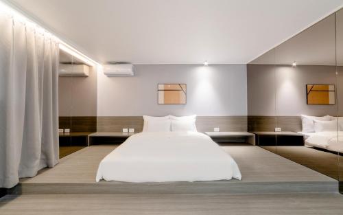 a bedroom with a white bed and two pillows at Aank Hotel Incheon Bupyeong in Incheon