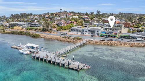 an aerial view of a dock with boats in the water at Waterfront On Market in Merimbula