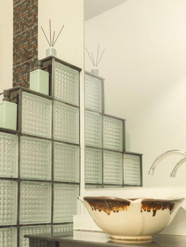 a bathroom with a bowl on top of a table at Baansuanprannok Hotel in Bangkok
