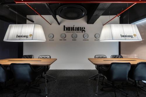 two tables and chairs in a room with two lights at Bintang Collectionz Hotel in Kuala Lumpur