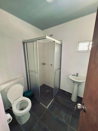 a bathroom with a shower and a toilet and a sink at Hostal tercer cielo Restaurante Fidelio in Santa Marta