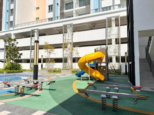a playground with a slide in a building at Leisure Home - 7pax Camping Theme in Kampong Lobok