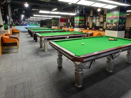 a row of green pool tables in a room at PACI Hotel&SPA in Sihanoukville