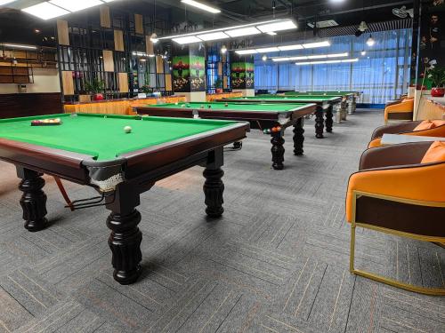 a row of green pool tables in a room at PACI Hotel&SPA in Sihanoukville