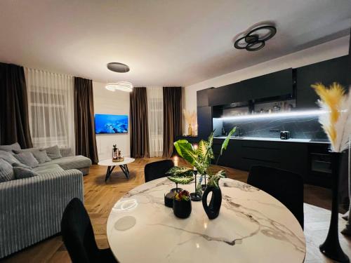a living room with a table and a couch at Newly Renovated 1BR in Kaunas Downtown Central Location Fast WiFi in Kaunas