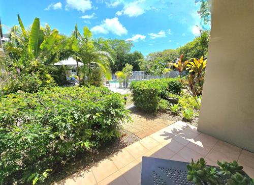 a view of a garden with trees and bushes at Noosa River Retreat Holiday Apartments in Noosaville