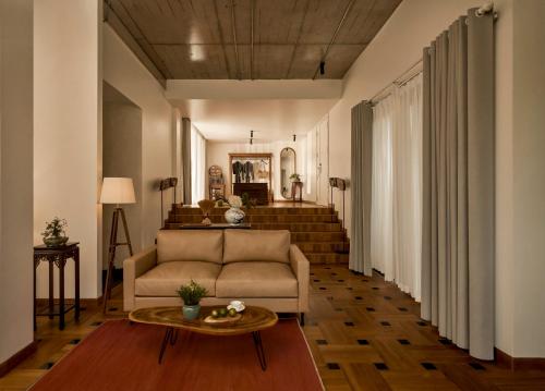 a living room with a couch and a table at aNhill Boutique in Hue