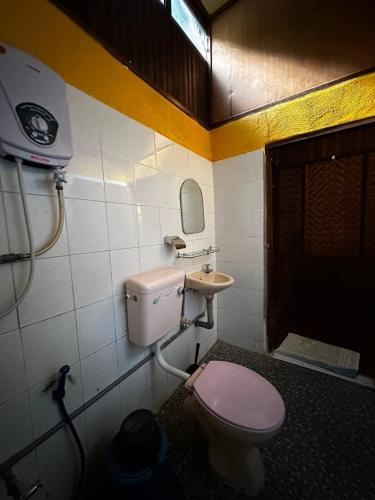 a bathroom with a pink toilet and a sink at The Reef Chalet Perhentian Island - Bluestar in Perhentian Island