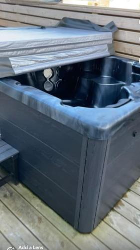 a blue sink sitting on top of a deck at Cosy private home with a hot tub on a private deck, close to Airport in Njarðvík