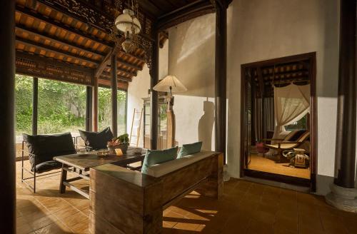 a living room with a couch and a table at aNhill Boutique in Hue