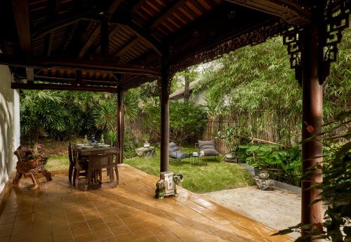 a pavilion with a table and chairs on a patio at aNhill Boutique in Hue