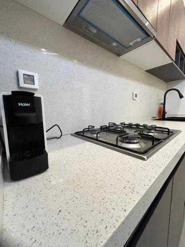 a kitchen with a stove and a counter top at LUXURY PREMIUM #POINT e in Point E