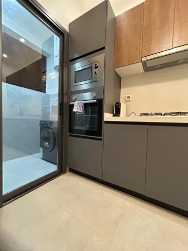 a kitchen with stainless steel appliances and a window at LUXURY PREMIUM #POINT e in Point E