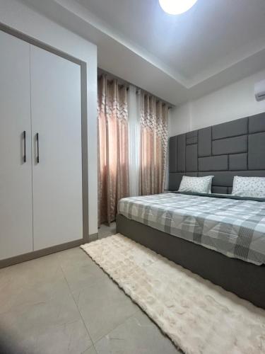 a bedroom with a bed and a sliding door at LUXURY PREMIUM #POINT e in Point E