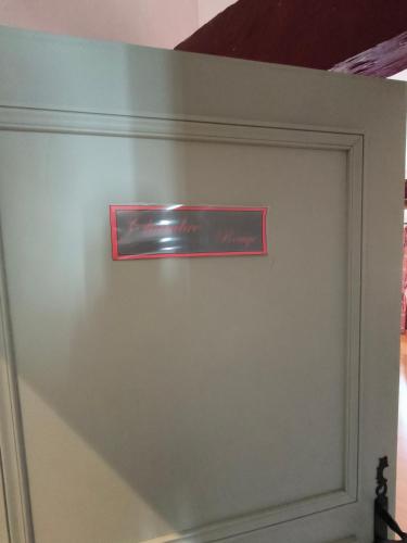 a door with a red sign on top of it at Le Peyret in Serres-Castet
