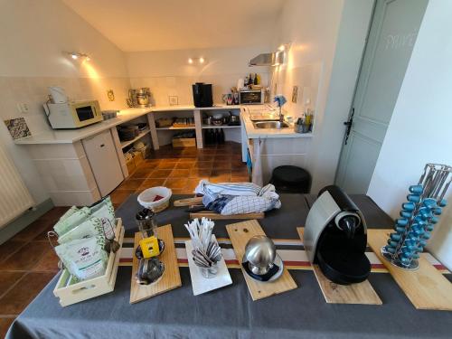 a kitchen with a table withtools and a counter top at Le Peyret in Serres-Castet