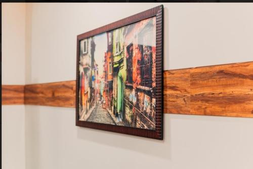 a framed picture of a city on a wall at Northern Suites Bahria town in Rawalpindi