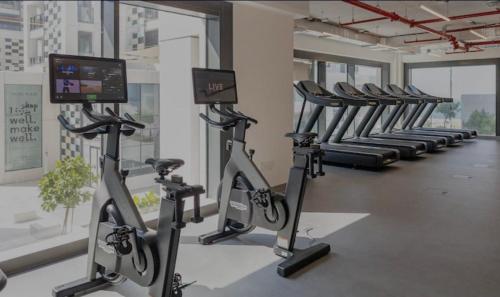 a row of exercise bikes in a gym at The Blue City 1BR - Al Reem Island Beach View in Abu Dhabi