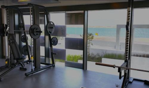 a gym with a view of the ocean from a room at The Blue City 1BR - Al Reem Island Beach View in Abu Dhabi