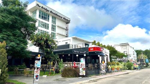 a building on the side of a street at The Bridge Residence Hotel in Kanchanaburi