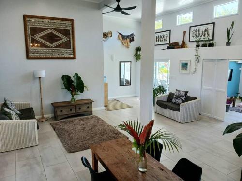 a large living room with a table and chairs at Coastal Retreat Holiday Home Rarotonga in Oneroa