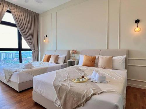 a bedroom with two beds with a tray on it at 3BR-Countryroad-Paradigm Residence by Guesthouse-6-8Pax in Johor Bahru