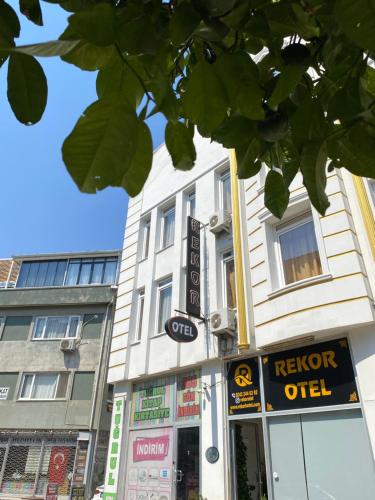 a white building with a sign for a keroper at REKOR OTEl in Antalya