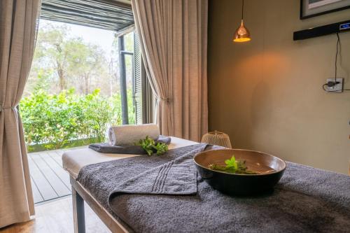 a room with a bowl on a table with a window at Mokuti Etosha in Namutoni