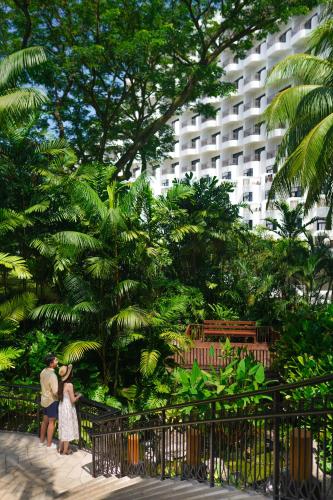 a man and woman standing in front of a building at Shangri-La Rasa Sentosa, Singapore in Singapore