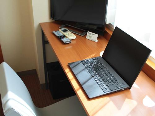 a laptop computer sitting on top of a desk at Comfort Inn Karuizawa in Karuizawa