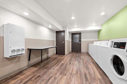 a laundry room with a washer and dryer at WoodSpring Suites Huntsville - Research Park in Huntsville