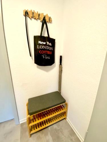 a black bag hanging on a wall next to a bench at Cottbus-Apartments - Beige Apartment I privat I Wifi I Küche in Cottbus