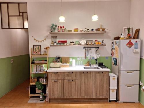 a kitchen with a refrigerator and a sink at Good Stay in Tainan