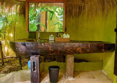 a bathroom with a rusty sink and a mirror at Earth Elements Eco Resort in Ban Bu Hua Chang