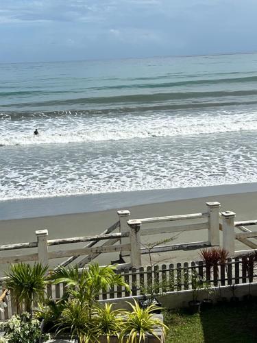 a view of the beach with a person in the ocean at Corazon De Baler in Baler