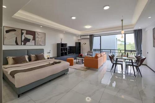 a bedroom with a large bed and a dining room at Kigali Oasis luxury Apartment No 606 in Kigali