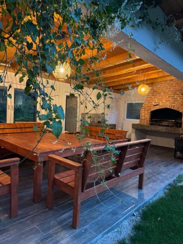 a wooden table and benches on a patio at Villa Rivus in Sarajevo