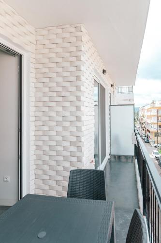 a balcony with a table and chairs on a building at MAGNOLIA SUITES in Nafpaktos