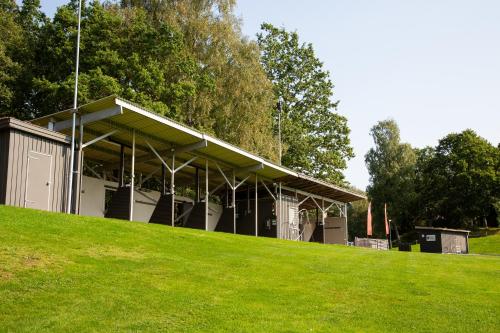 a building on top of a grassy hill at Alingsås Golfklubb in Alingsås