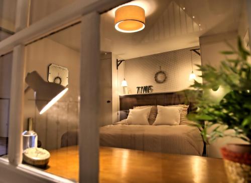a bedroom with a bed in a room with a table at Gîte le Grenier GRAY in Gray