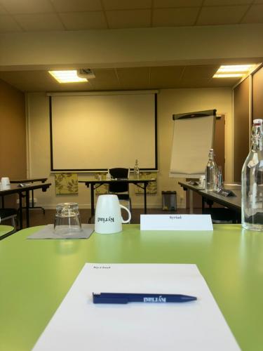 a pen sitting on top of a table in a classroom at Kyriad Rennes Sud - Cesson Chantepie in Chantepie